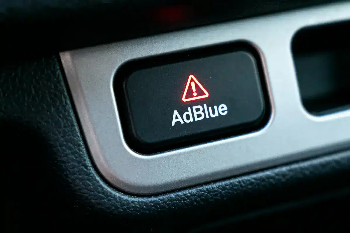 Alerte AdBlue activée, voyant rouge, tableau de bord automobile.